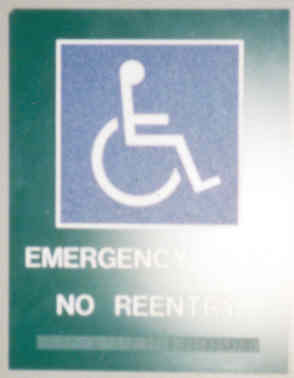 Picture of a sign with a disability symbol. The text under it reads 'EMERGENCY EXIT. NO REENTRY', which is repeated in braille below.