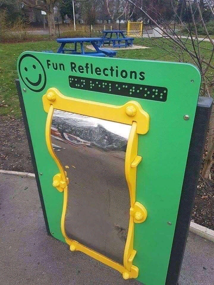 Playground toy with a distorting mirror and the heading 'Fun reflections' in print - and braille